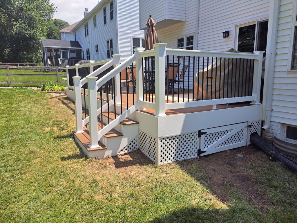 back deck with a lattice bottom and access gate 