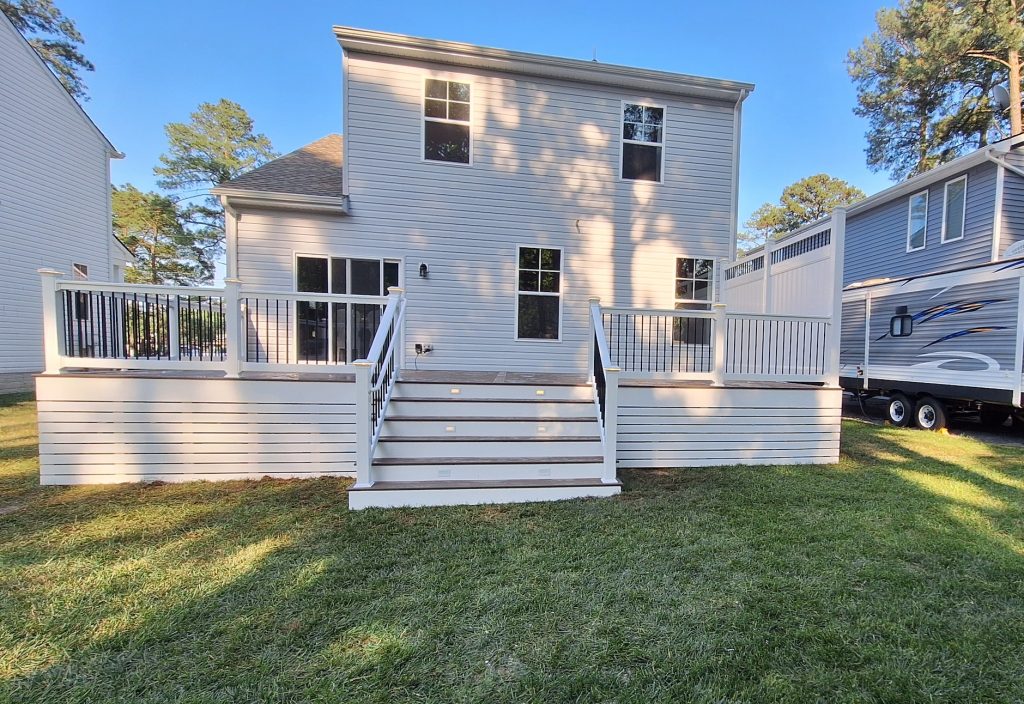 Dark Roast TimberTech deck with lighting, privacy panel, and horizontal deck skirting 