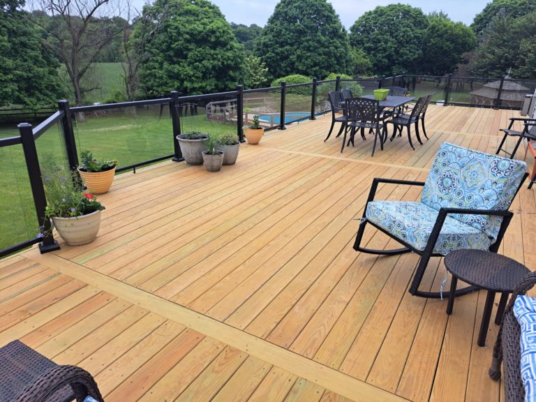 Wood Pressure Treated wood deck with aluminum railing with glass inserts