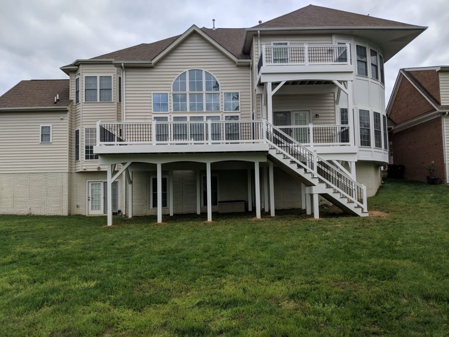 2 Level Deck with Trex Select Saddle Decking with White Washington Railing and Black Aluminum Balusters + Fascia and Support Posts and Beams are wrapped in White Vinyl