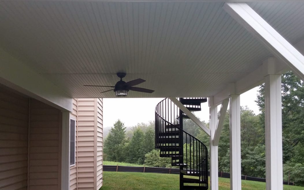 30-Finished underside of deck with drainage and ceiling fan and spiral stairs and wrapped beams and supports