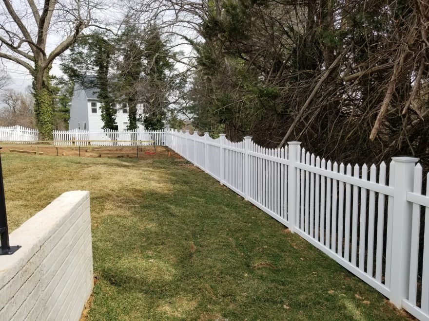 5_ high white pvc picket fence in contemporary style with pointed pickets and new england post caps with a concave pattern