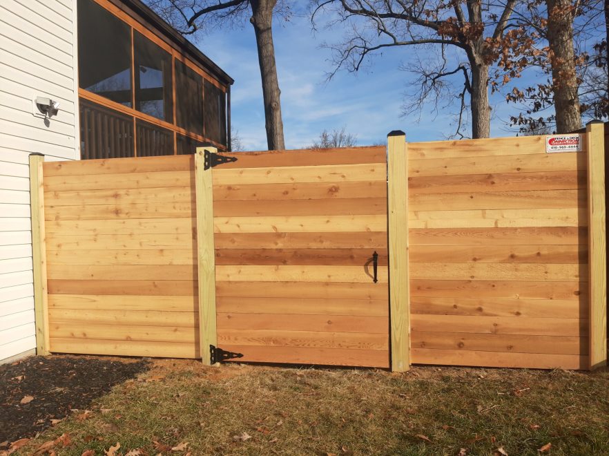 6 foot Horizontal cedar fencing with no spacing between the pickets and single flat top walk gate