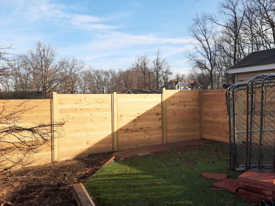 6 foot Horizontal cedar stepped fencing with no spacing between the pickets with standard black post caps (2)