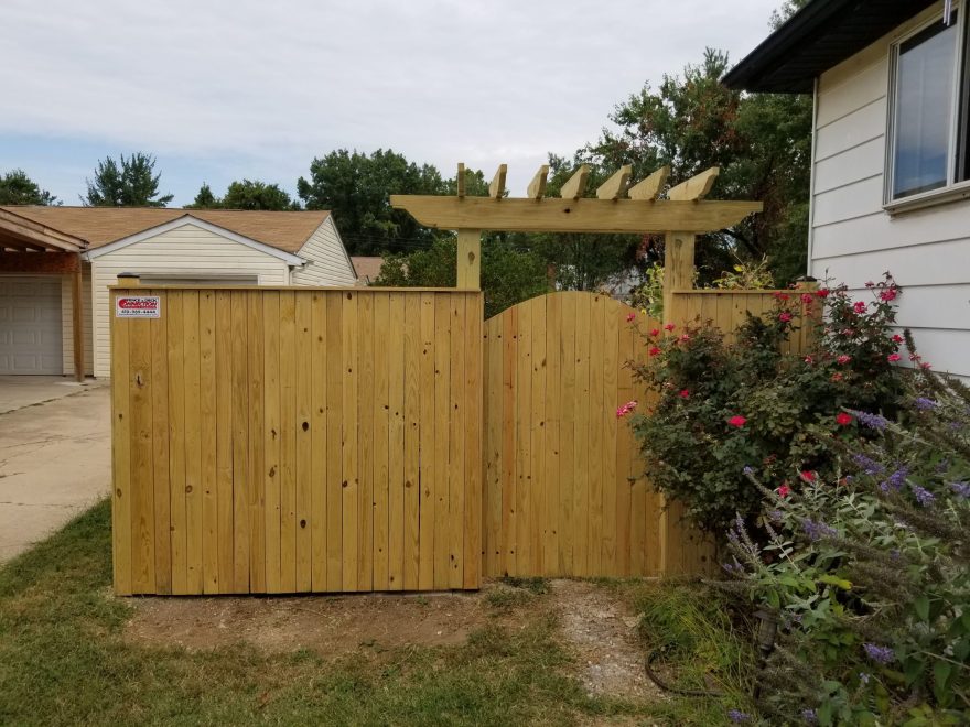 6 foot high Pressure Treated Vertical Board Privacy Fence with an arched walk gate + Trellis over the gate