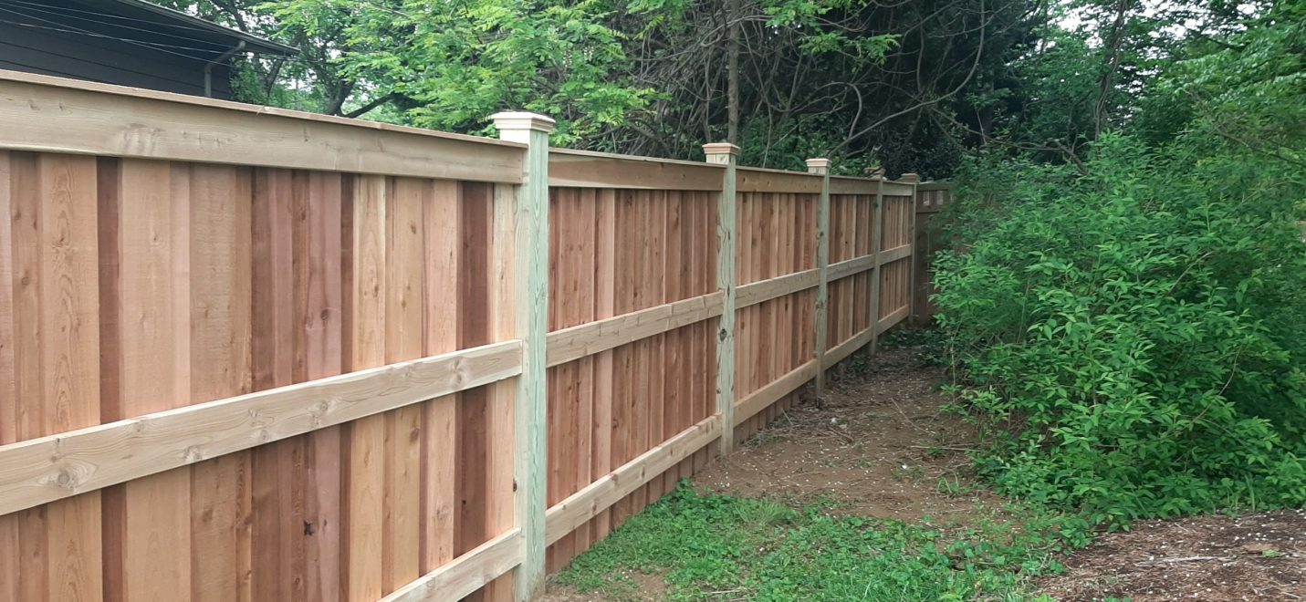 6_ high cedar board and batten privacy fencing with 6x6 post and cedar New England post caps Fence to have 1x6 cedar fascia board on top only 2