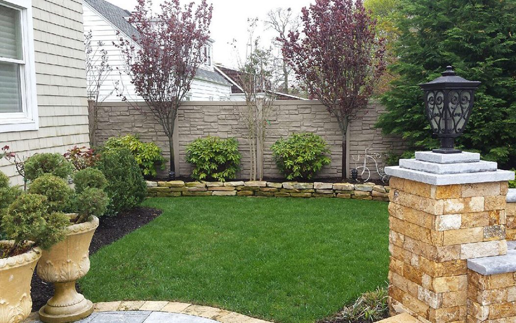 8 Brown Granite Ecostone Simtek Fence in backyard