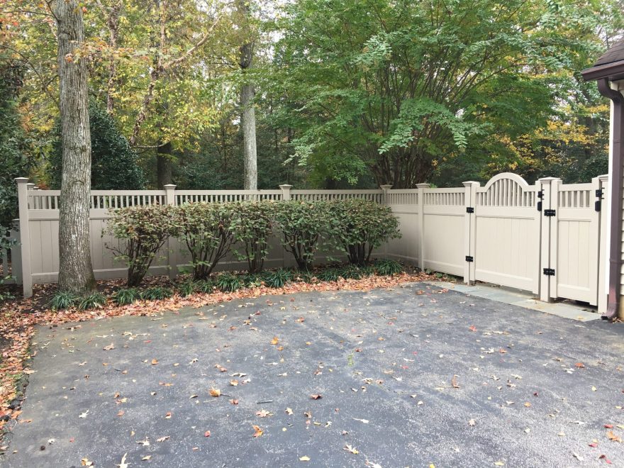 Khaki Vinyl Privacy Fence with closed spindles and arched gate