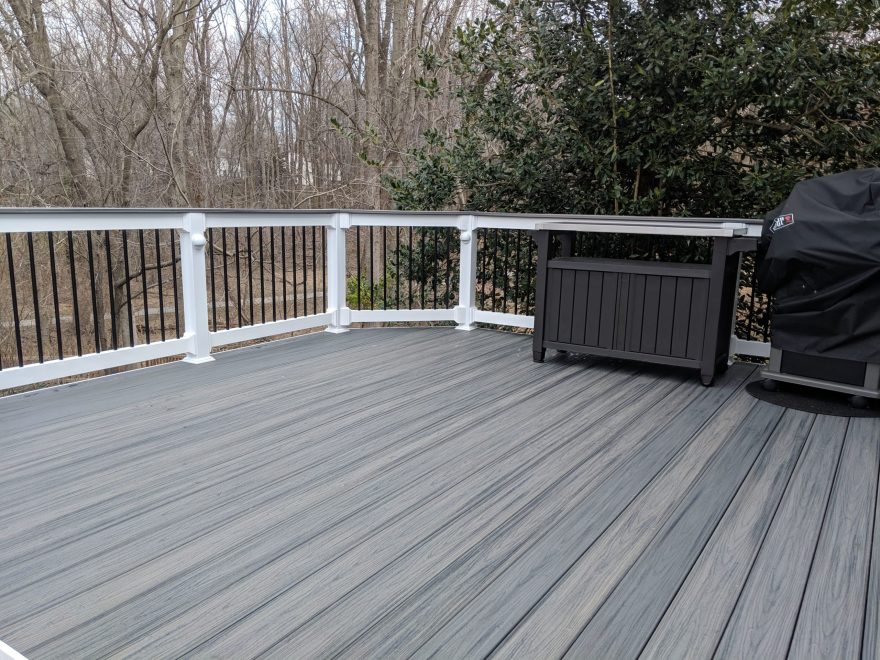 TimberTech Azek Island Oak Decking with White Lincoln Vinyl railing with continuous Cocktail Rail and Eye Ball Lights in Posts