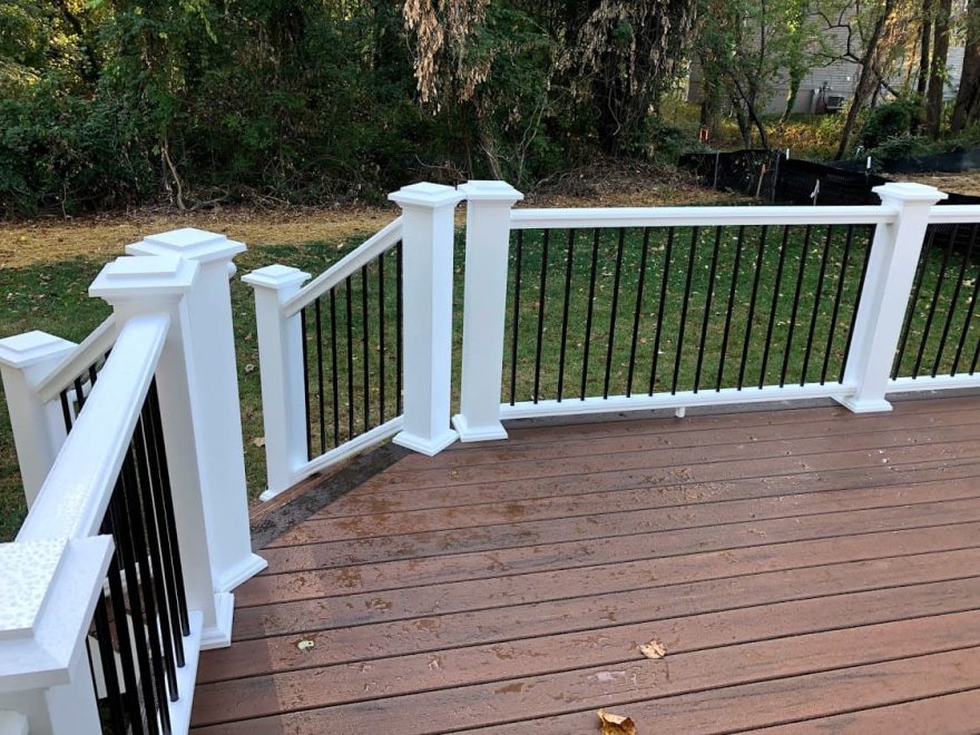 TimberTech Pro Legacy Collection Sapele Decking with Mocha Feature Board and White TimberTech Permier Handrail with Round Aluminum Hammered Bronze Balusters