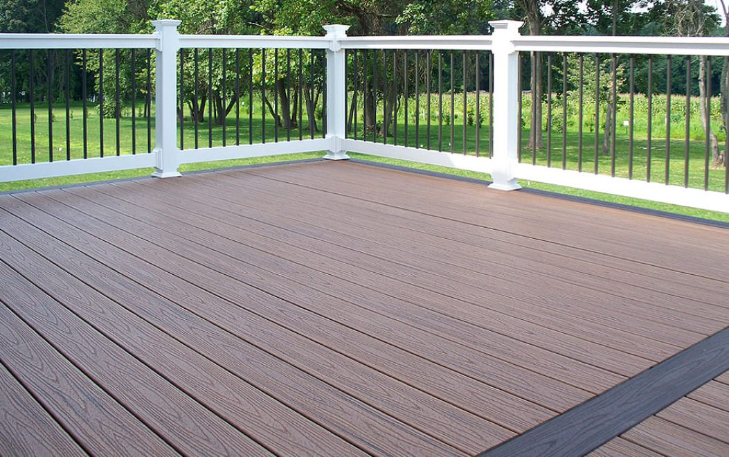 Trex Composite deck with feature board white vinyl railing black ballusters