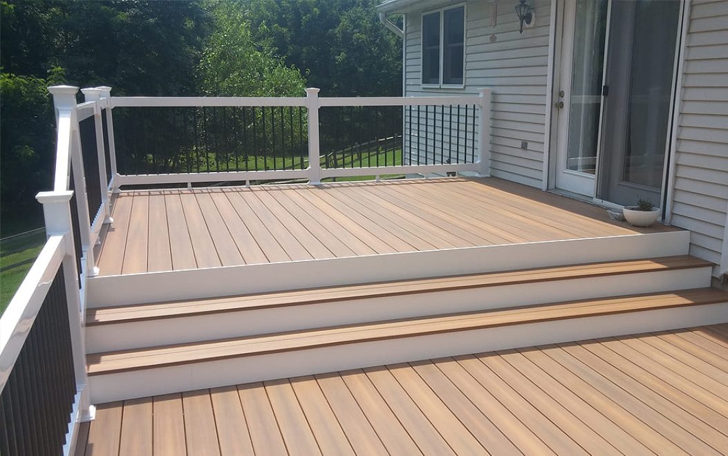 Trex Composite deck with steps and vinyl railing with black aluminum ballusters