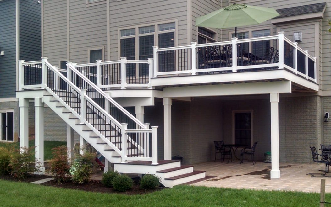 Trex Composite deck with white vinyl railing & black ballusters, facia board and wrapped beams & posts