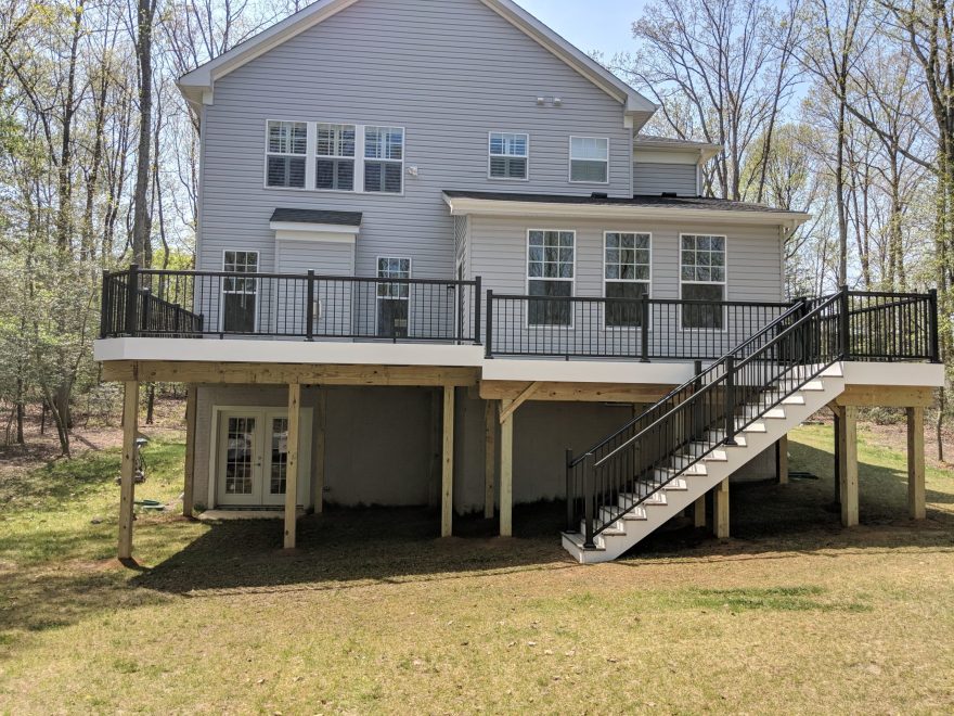 Trex Transcend Island Mist Decking with Black Ultralox Aluminum Railing and White VInyl Fascia around perimeter of deck in Arnold MD