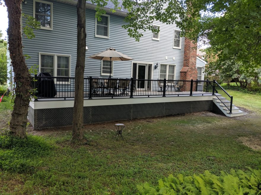 Trex Transcend Island Mist Decking with Ultralox Black Aluminum Railing and Gray Vinyl Lattice underneath deck in Ellicott City MD