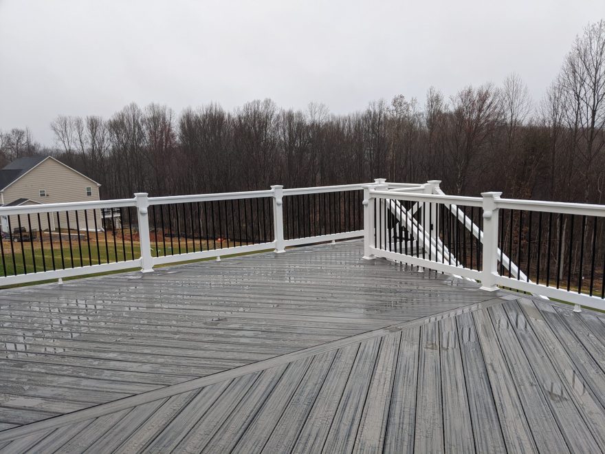 Trex Transcend Island Mist deck boards in a Herringbone layout with White Washington Vinyl Railing and Black Round Aluminum Balusters in Eldersburg, MD 2