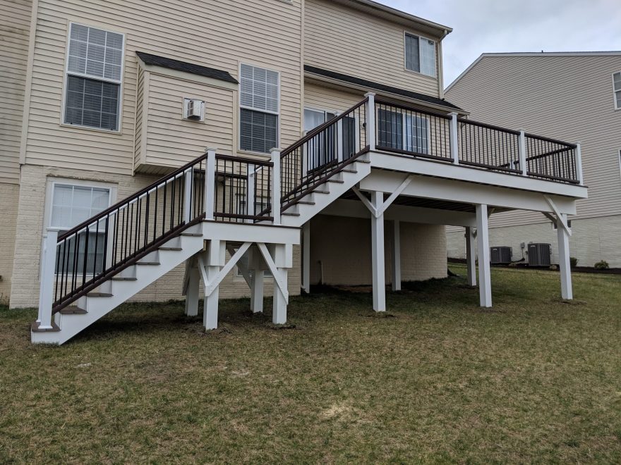 Trex Transcend Spiced Rum Deck Boards with Trex composite railing in matching Spiced Rum with white composite posts and black aluminum balusters in Ellicott City MD