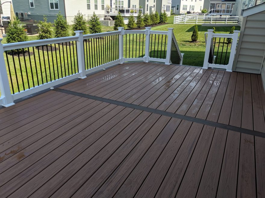 Trex Transcend Tiki Torch Deck Boards +Spiced Rum Feature Board with White Washington Vinyl Railing and Black Aluminum Balusters in Gambrills MD